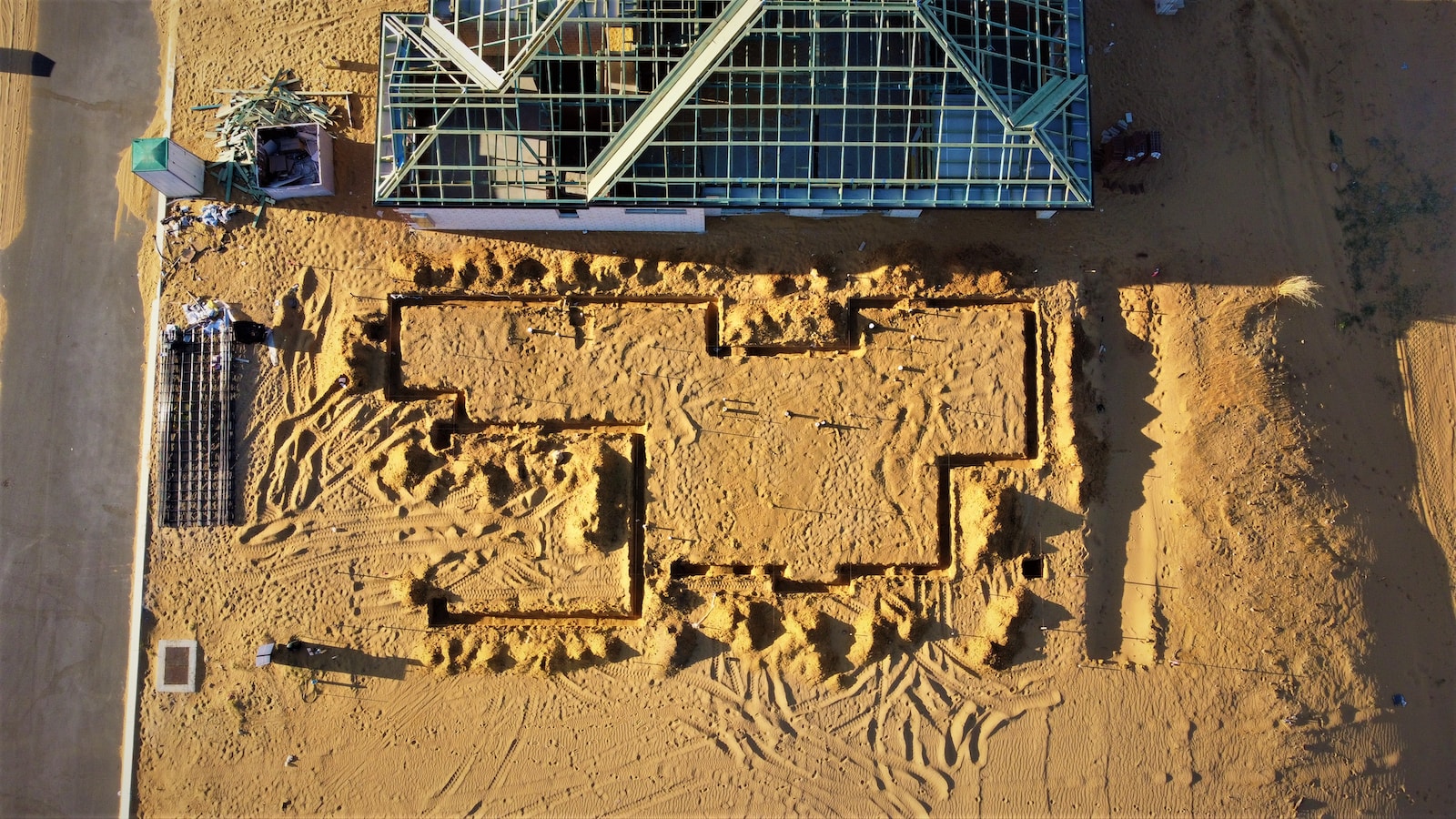 an aerial view of a building in the sand