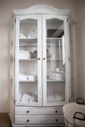 white wooden framed glass cabinet